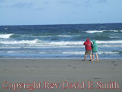 Couple Stroll Along Beach